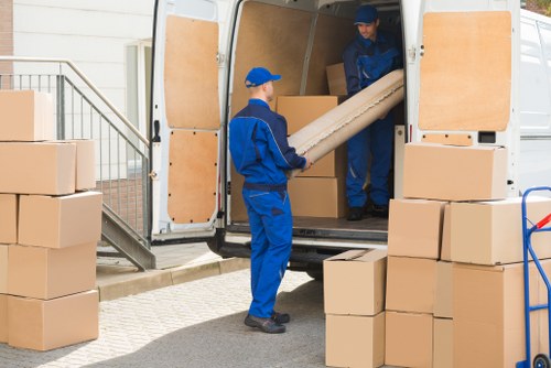 Office removals planning in Isleworth with packed boxes and business furniture