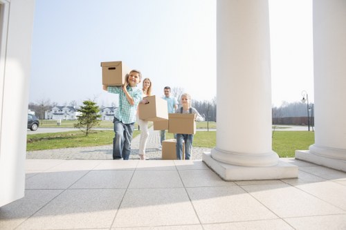Local movers carrying furniture through a residential street