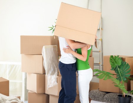Moving team handling furniture in a residential Isleworth street
