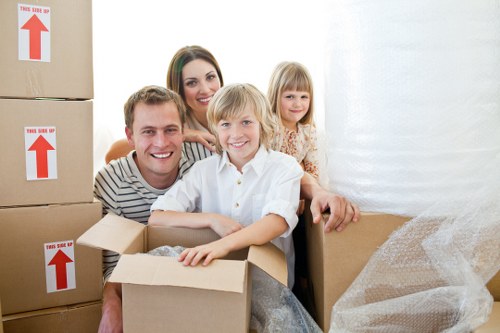 Professional movers loading boxes into a removal van in Isleworth