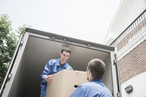 Professional movers loading furniture into a van in Isleworth