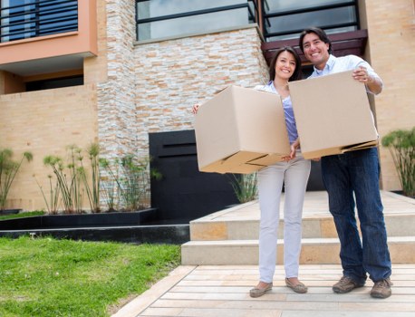 Movers loading boxes and furniture into a van